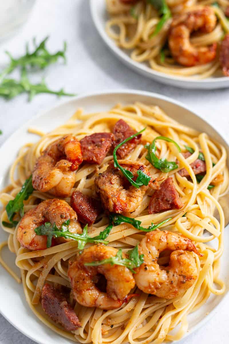 Pasta with shrimp, chorizo, and arugula.