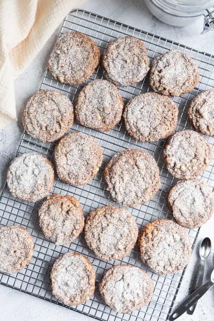 A tray of almond cocoa cookies dusted with powdered sugar.