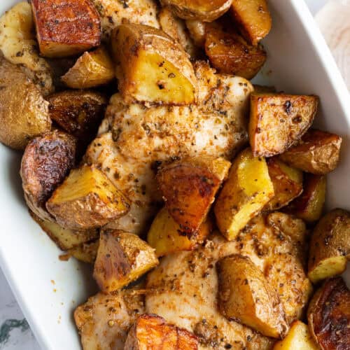 A platter of vinegar chicken thighs and potatoes.