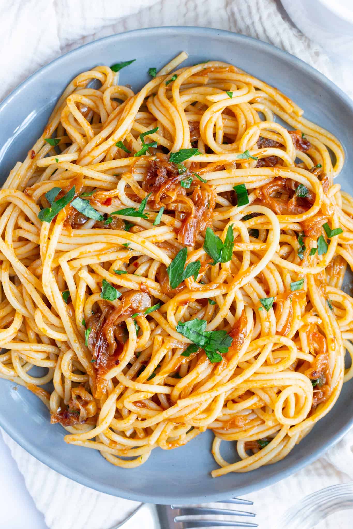 A heaping plate of caramelized shallot pasta combined with garlic, anchovies, and a touch of tomato paste.