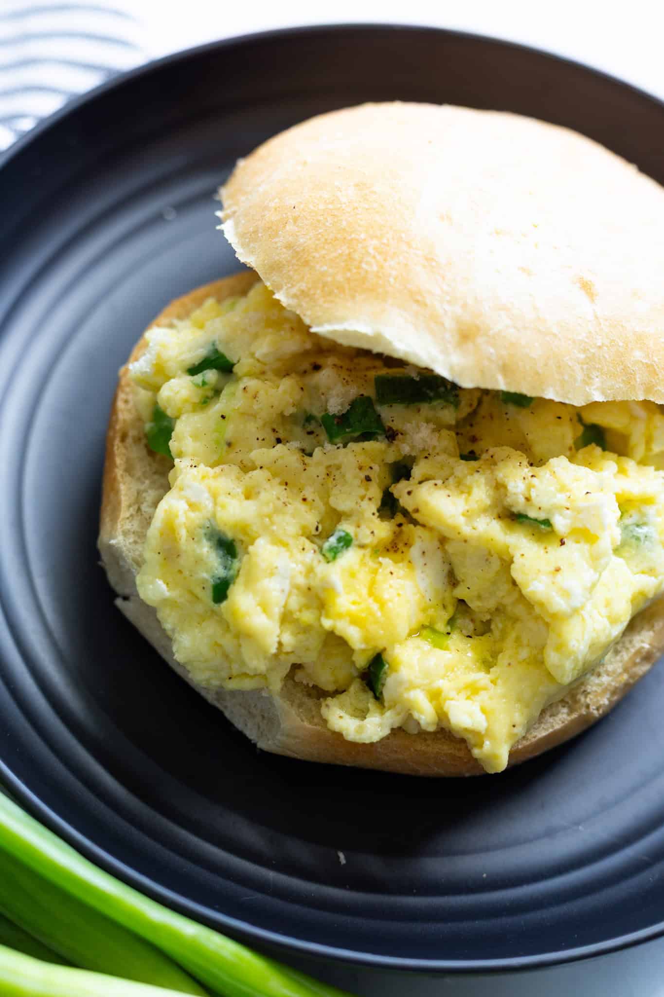 A sandwich roll filled with warm scrambled eggs and melted mozzarella.
