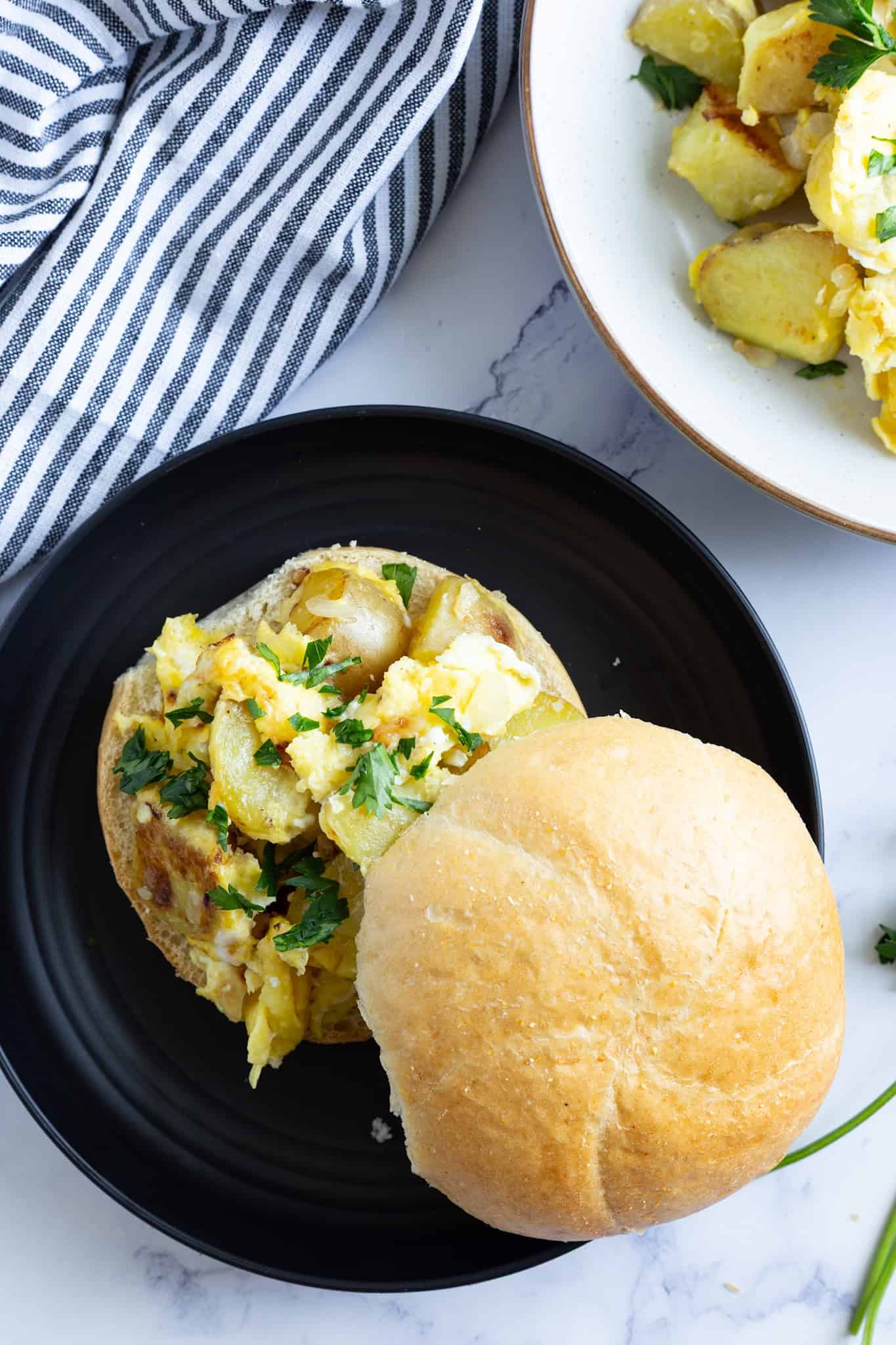 A sandwich roll filled with Italian potatoes and eggs.