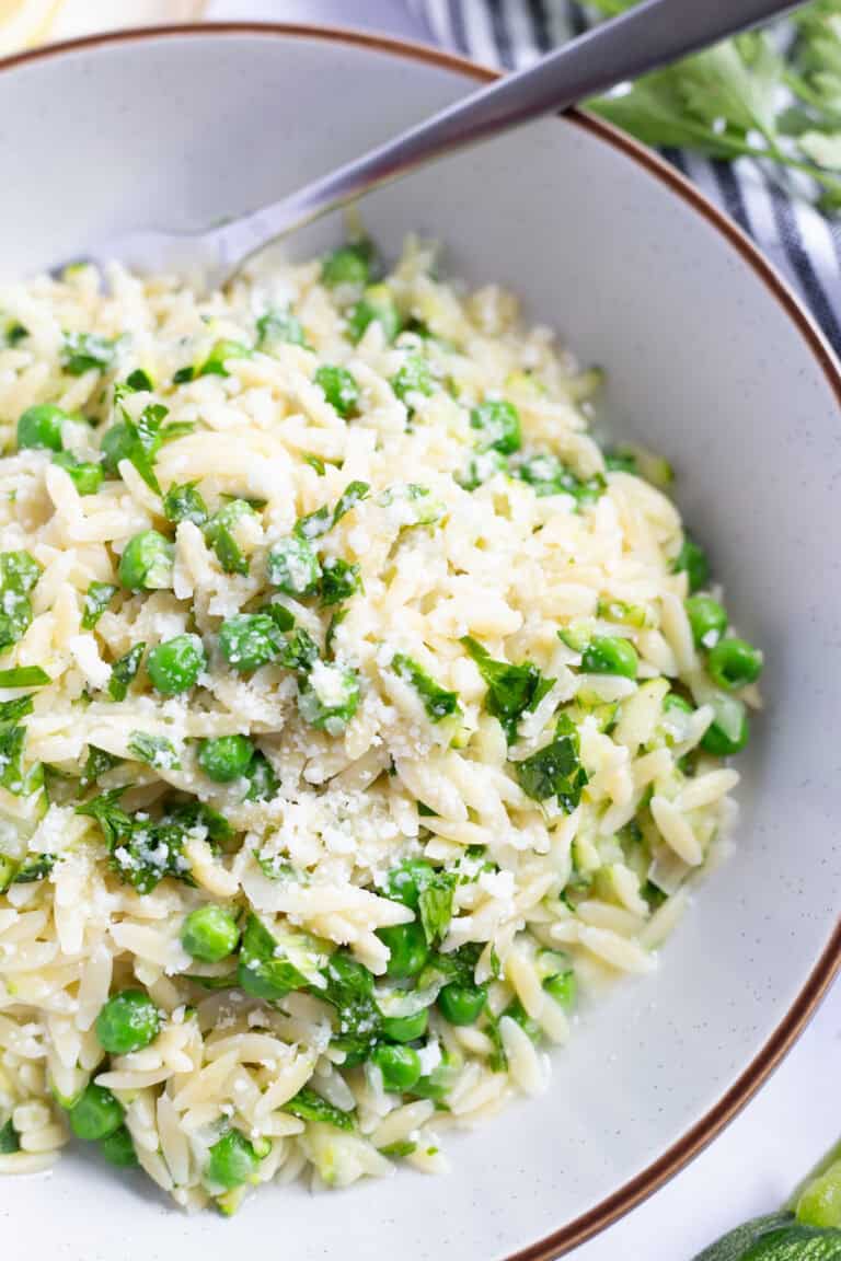 Lemon zucchini pasta garnished with grated Parmesan.