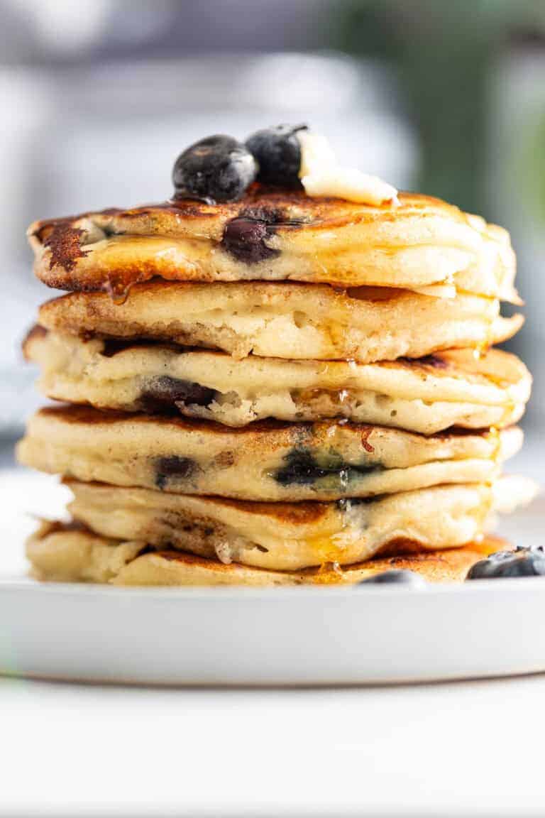 A stack of Betty Crocker pancakes with frozen blueberries.