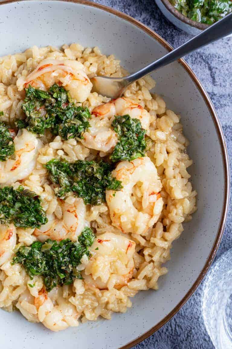 A bowl of shrimp and rice with Italian salsa verde.