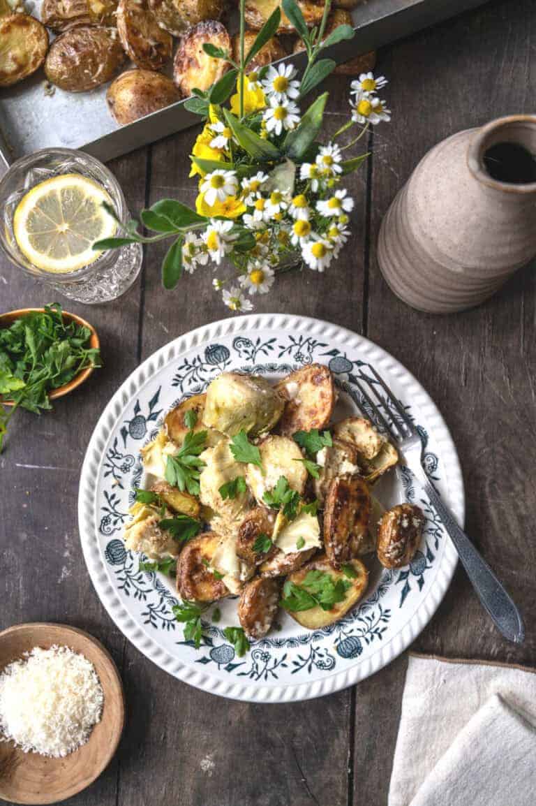 Creamy artichokes and potatoes garnished with parsley.